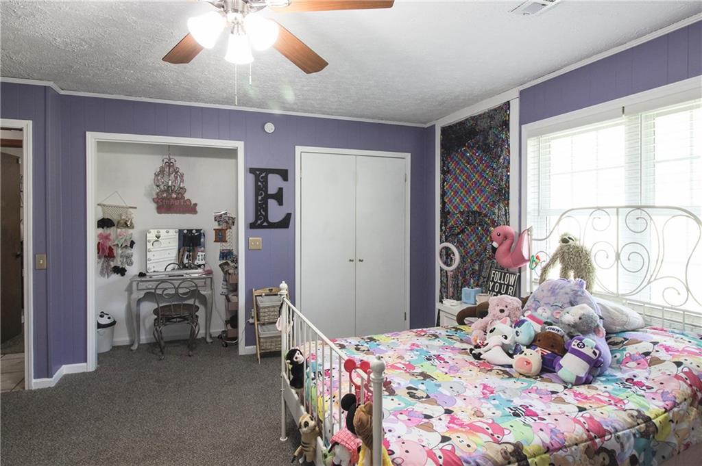 249 Cooper Road Southeast Calhoun, GA 30701 - Photo 20 of 62 a bedroom with a bed and a chandelier
