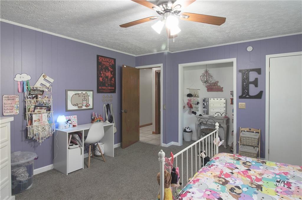 249 Cooper Road Southeast Calhoun, GA 30701 - Photo 21 of 62 a bedroom with furniture and a chandelier fan