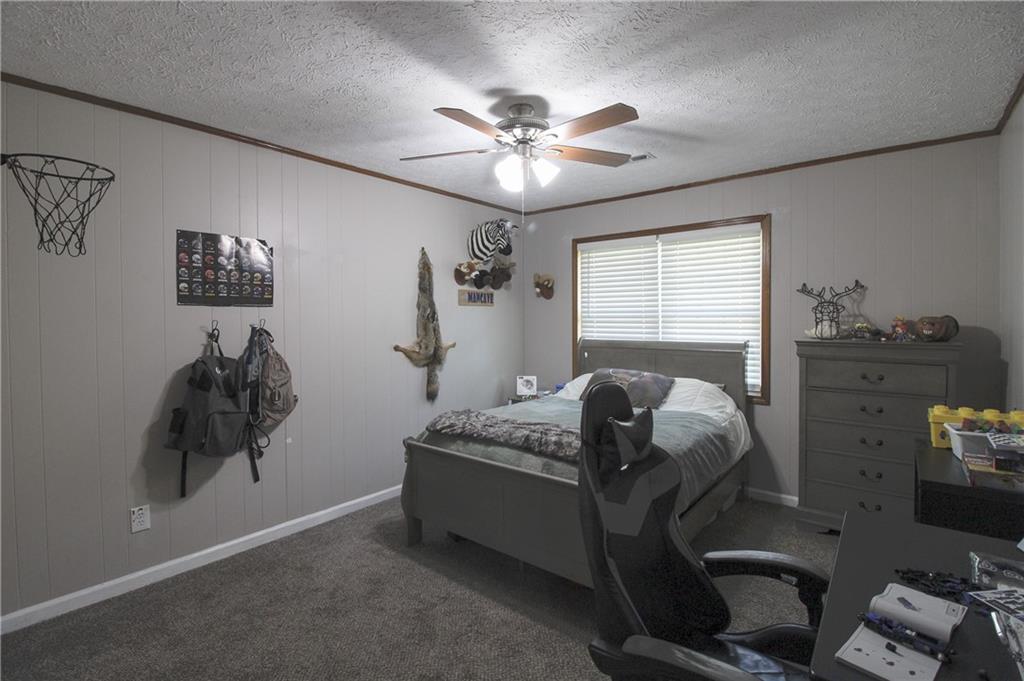 249 Cooper Road Southeast Calhoun, GA 30701 - Photo 22 of 62 a bedroom with a bed and a chandelier