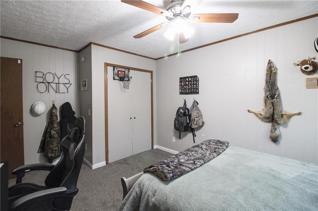 249 Cooper Road Southeast Calhoun, GA 30701 - Photo 24 of 62 a bedroom with a bed and a chandelier
