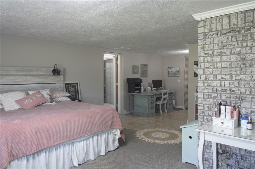 249 Cooper Road Southeast Calhoun, GA 30701 - Photo 34 of 62 a bedroom with a bed and furniture