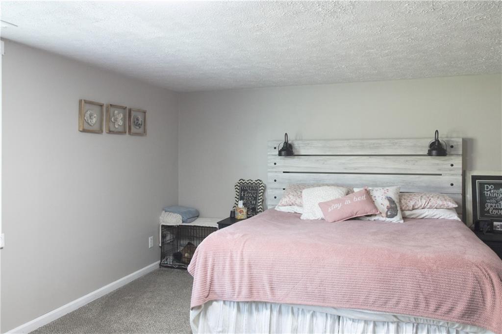 249 Cooper Road Southeast Calhoun, GA 30701 - Photo 35 of 62 a bedroom with a bed and a night stand