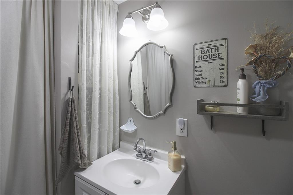 249 Cooper Road Southeast Calhoun, GA 30701 - Photo 39 of 62 a bathroom with a sink mirror and vanity