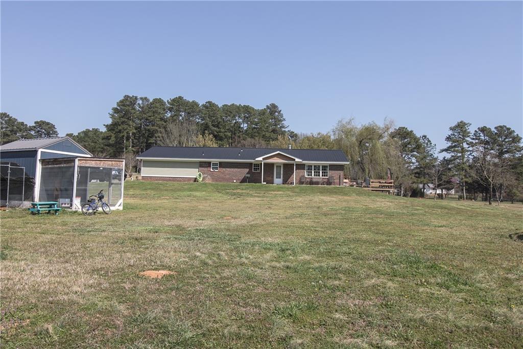 249 Cooper Road Southeast Calhoun, GA 30701 - Photo 44 of 62 a backyard of a house with table and chairs
