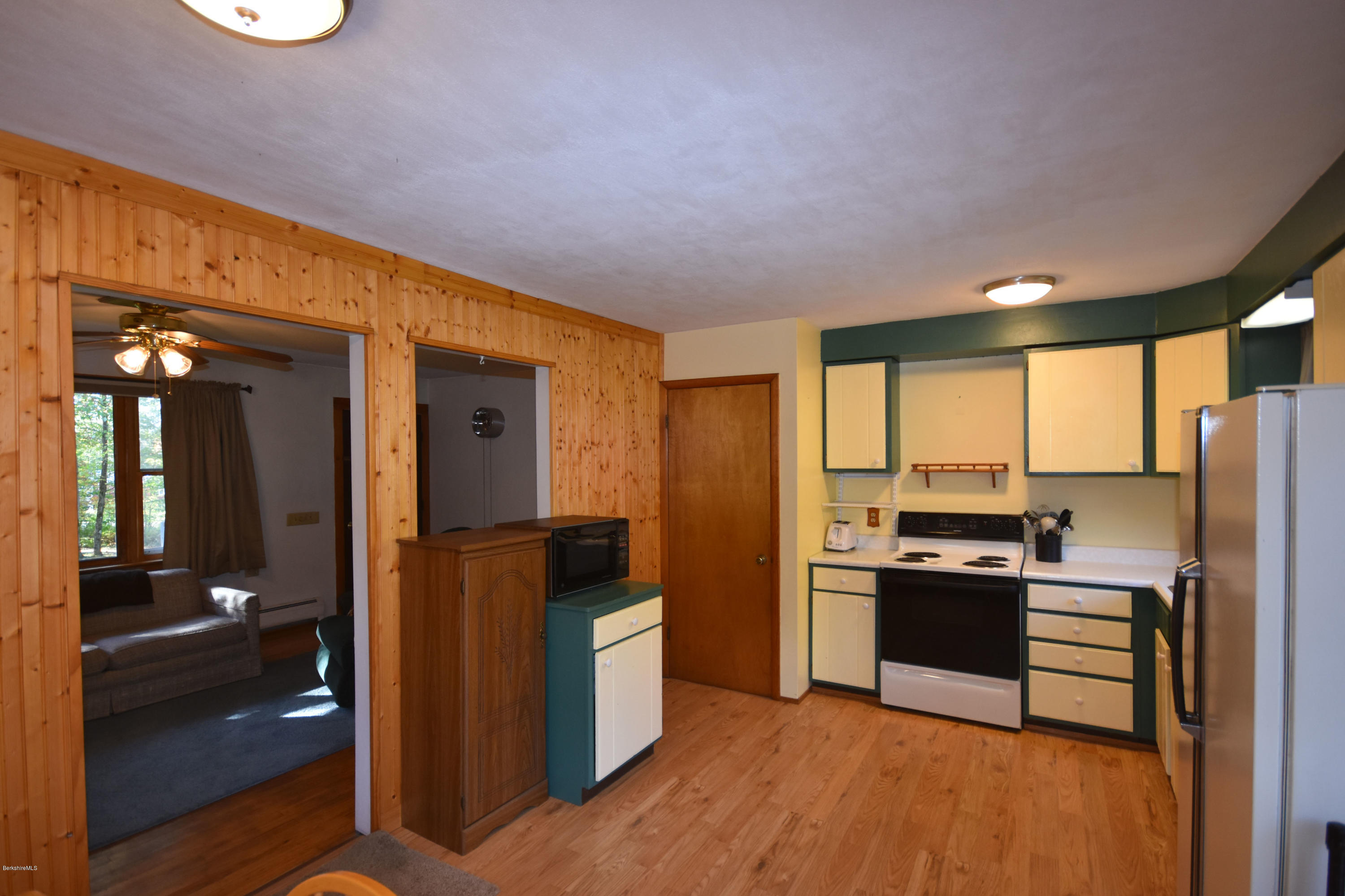 239 East Windsor Road Peru, MA 01235 - Photo 13 of 38 a kitchen with stainless steel appliances granite countertop a refrigerator a stove and a sink with wooden floor