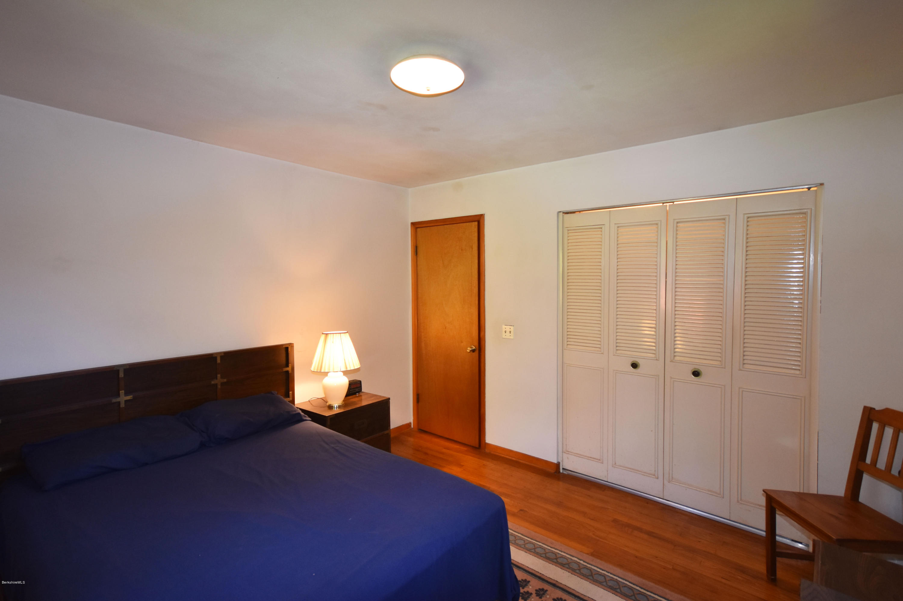 239 East Windsor Road Peru, MA 01235 - Photo 20 of 38 a bedroom with a bed and wooden floor
