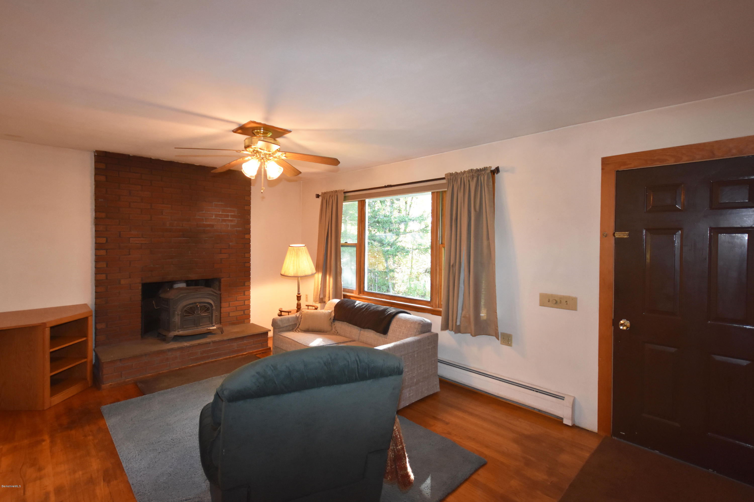 239 East Windsor Road Peru, MA 01235 - Photo 6 of 38 a living room with furniture and a fireplace