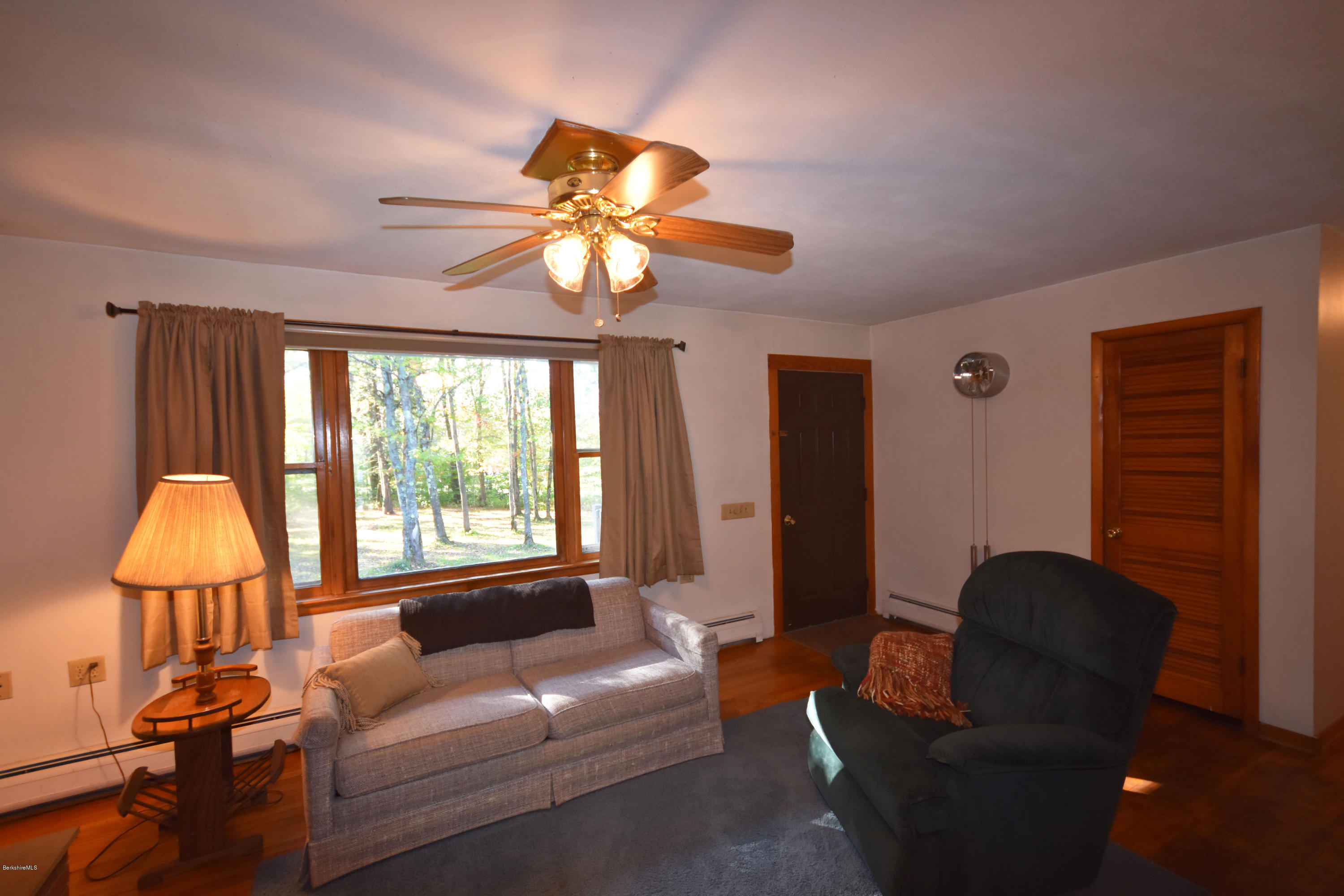 239 East Windsor Road Peru, MA 01235 - Photo 8 of 38 a living room with furniture a chandelier and a window