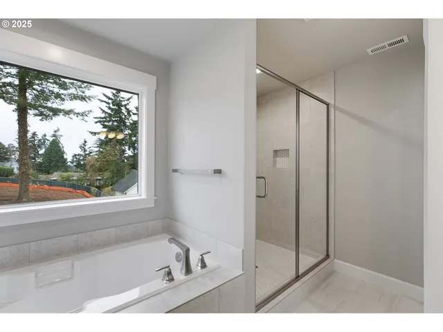 a bathroom with a bathtub and a shower