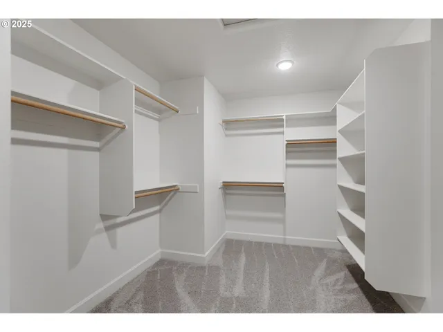 a view of walk in closet with empty racks