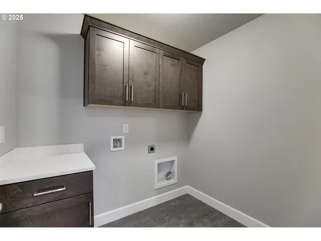 a view of an empty room and cabinet with mirror