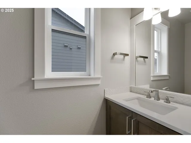 a bathroom with a sink vanity granite and a mirror