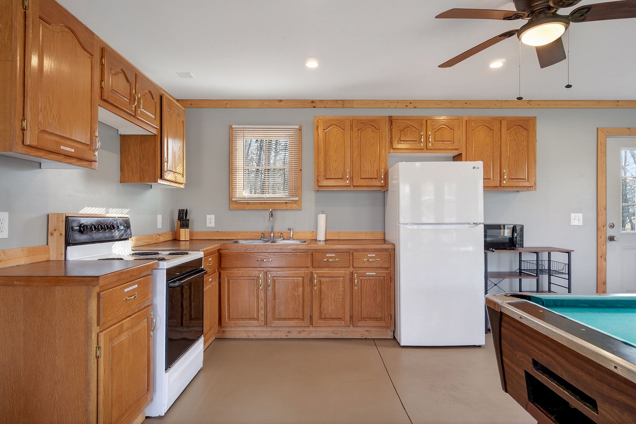 1680 Harrison Ferry Road McMinnville, TN 37110 - Photo 46 of 53 a kitchen with a refrigerator a stove a sink and a cabinets