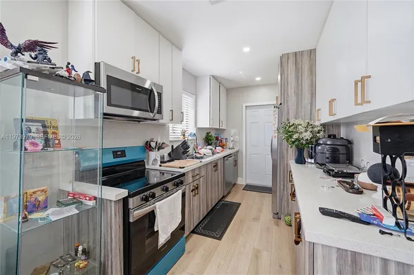 a kitchen with stainless steel appliances a sink stove and cabinets