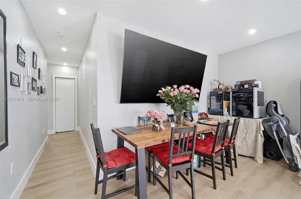 a dining room with furniture and wooden floor