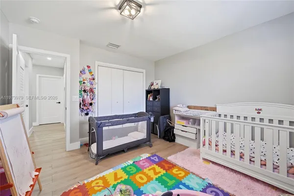 a bedroom with furniture and a baby crib
