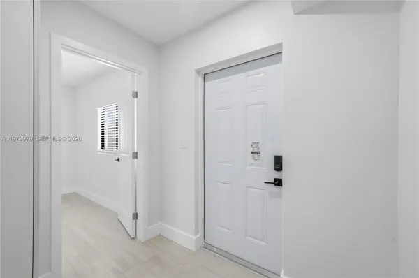 an empty room with cabinet and a window