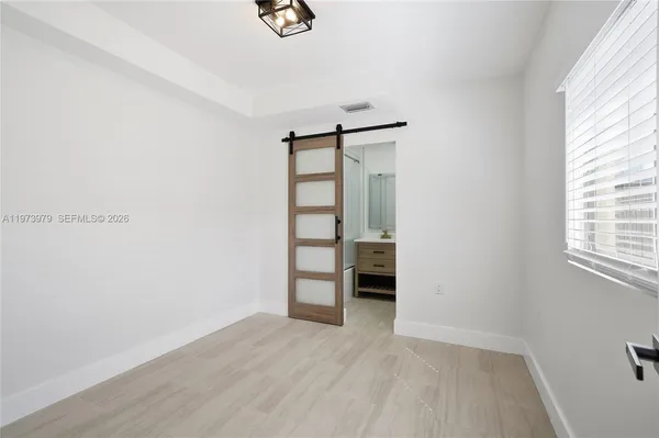a view of an empty room with a closet