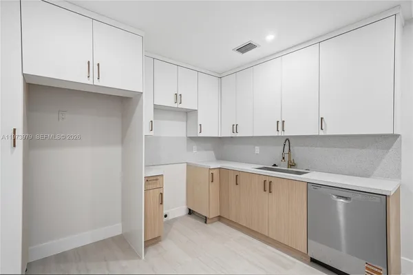 a view of a kitchen counter space a sink and dishwasher
