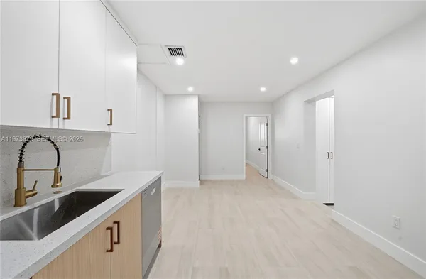 an empty room with windows and closet