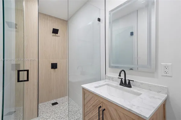 a view of a big house in a big yard with plants and large trees