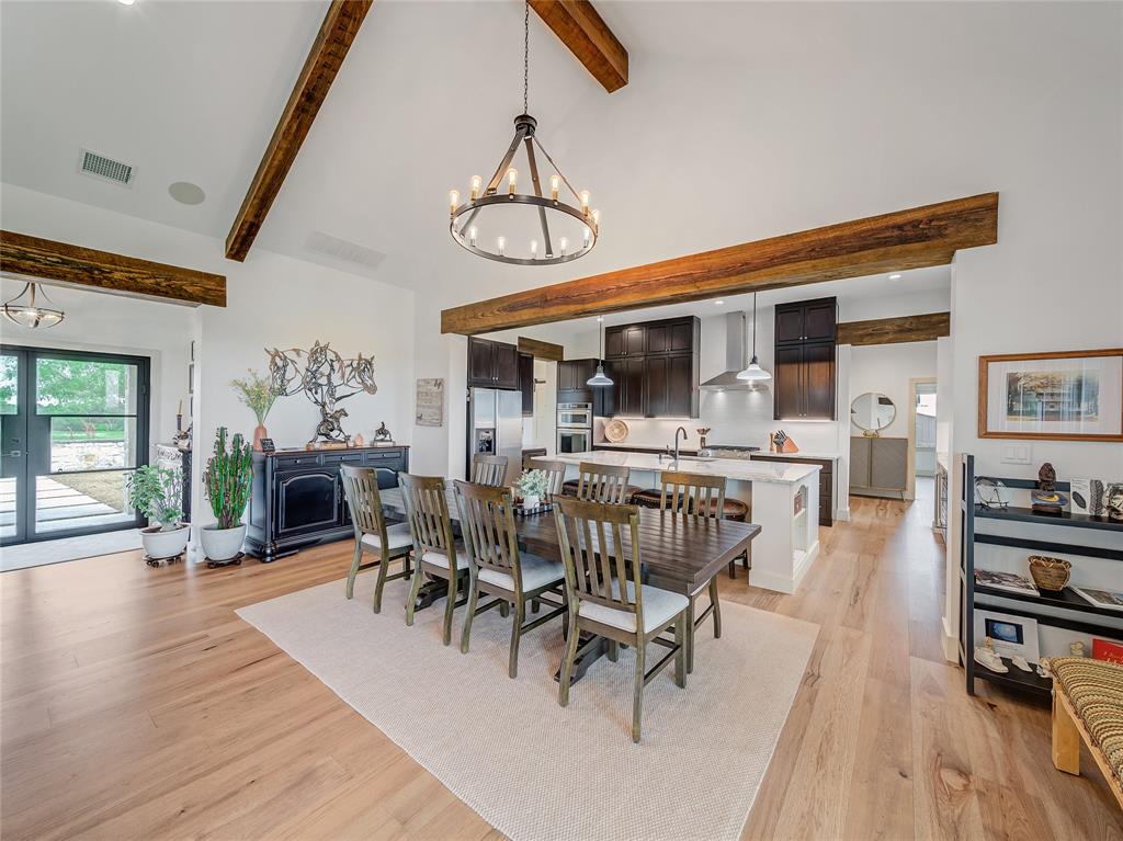 6362 Belz Road Sanger, TX 76266 - Photo 12 of 40 a dining room with wooden floor a chandelier a glass table and chairs