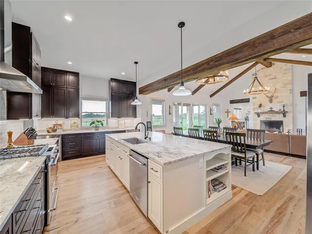 a kitchen with a stove a kitchen island a sink and a stove