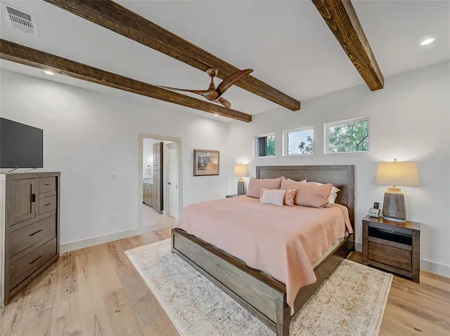 a bedroom with a bed and wooden floor