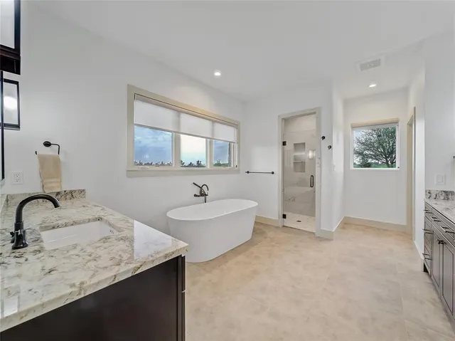 a bathroom with a double vanity sink and mirror
