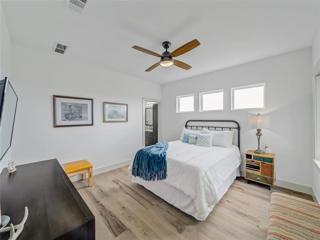 6362 Belz Road Sanger, TX 76266 - Photo 23 of 40 a bedroom with a bed and a chandelier