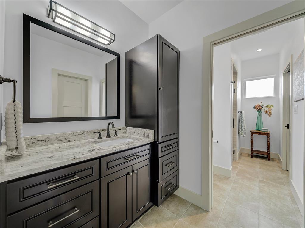 6362 Belz Road Sanger, TX 76266 - Photo 27 of 40 a bathroom with a sink a vanity and a mirror