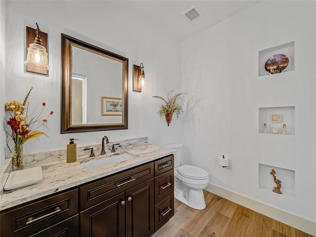 6362 Belz Road Sanger, TX 76266 - Photo 28 of 40 a spacious bathroom with a granite countertop sink a toilet and a mirror