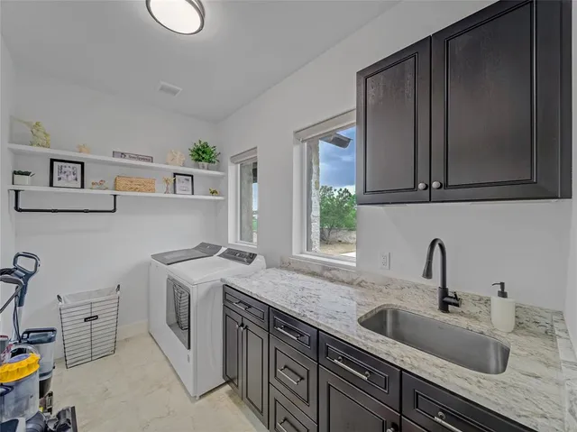 a kitchen with stainless steel appliances granite countertop a sink stove and cabinets