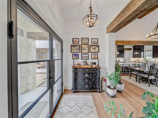 a view of an entryway with wooden floor and a potted plant