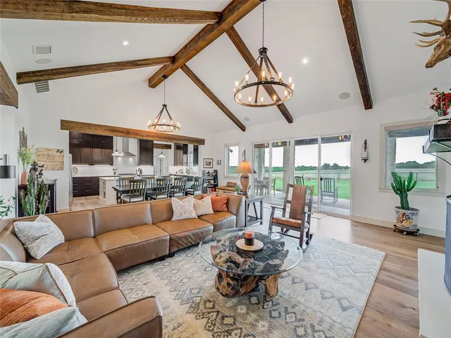 a living room with furniture ceiling fan and a large window