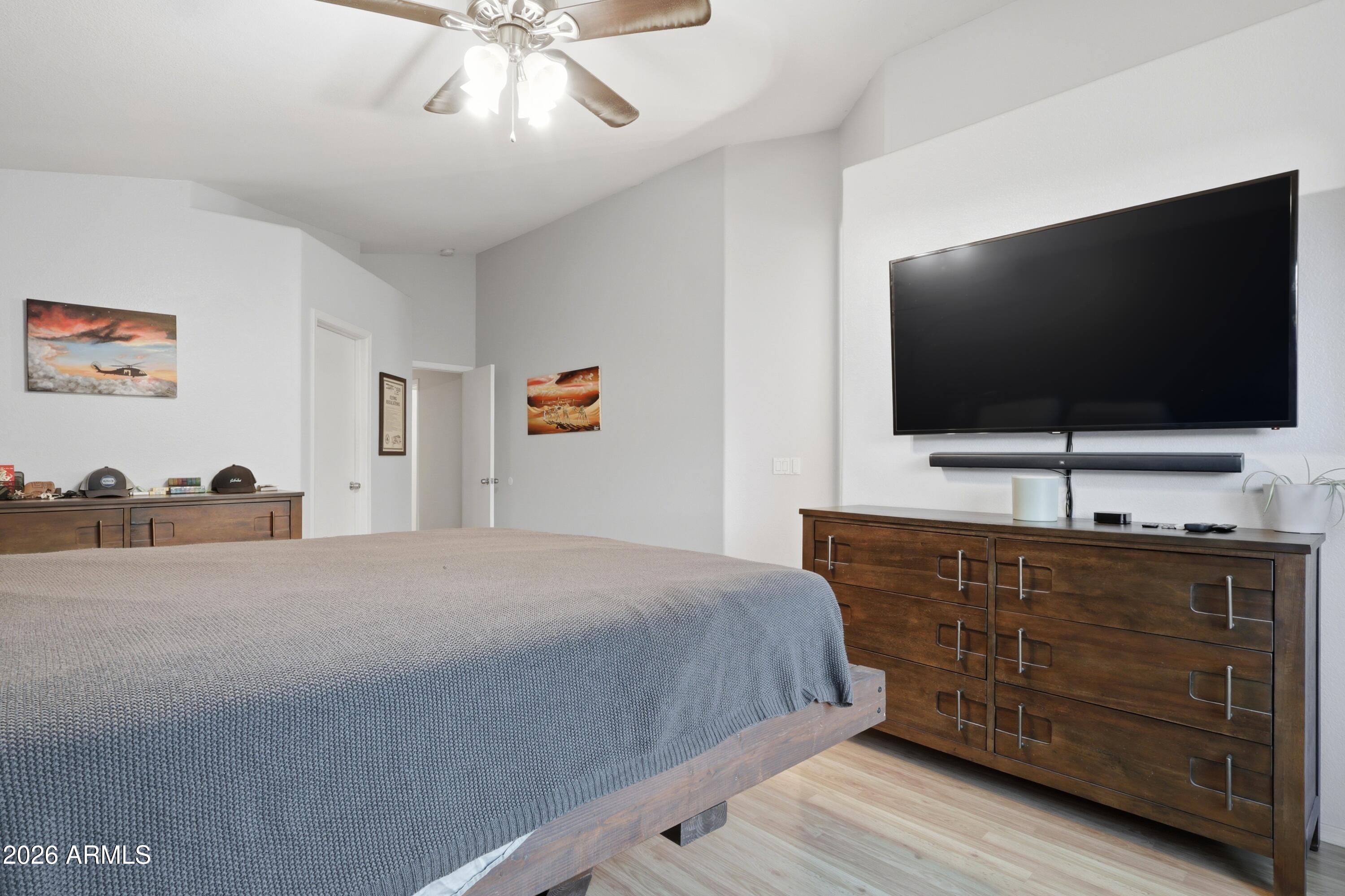 661 North Joshua Tree Lane Gilbert, AZ 85234 - Photo 15 of 47 a bedroom with a bed and a flat screen tv