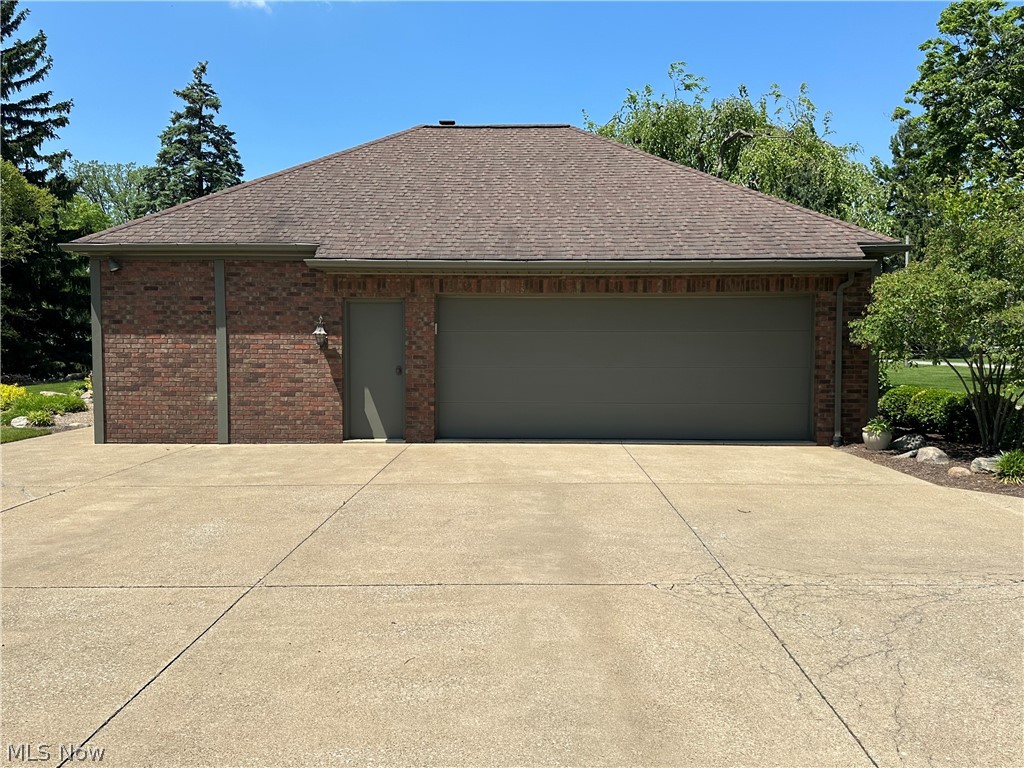 3985 Wiers Road Willard, OH 44890 - Photo 7 of 50 Brick exterior garage with a hip roof and asphalt shingles