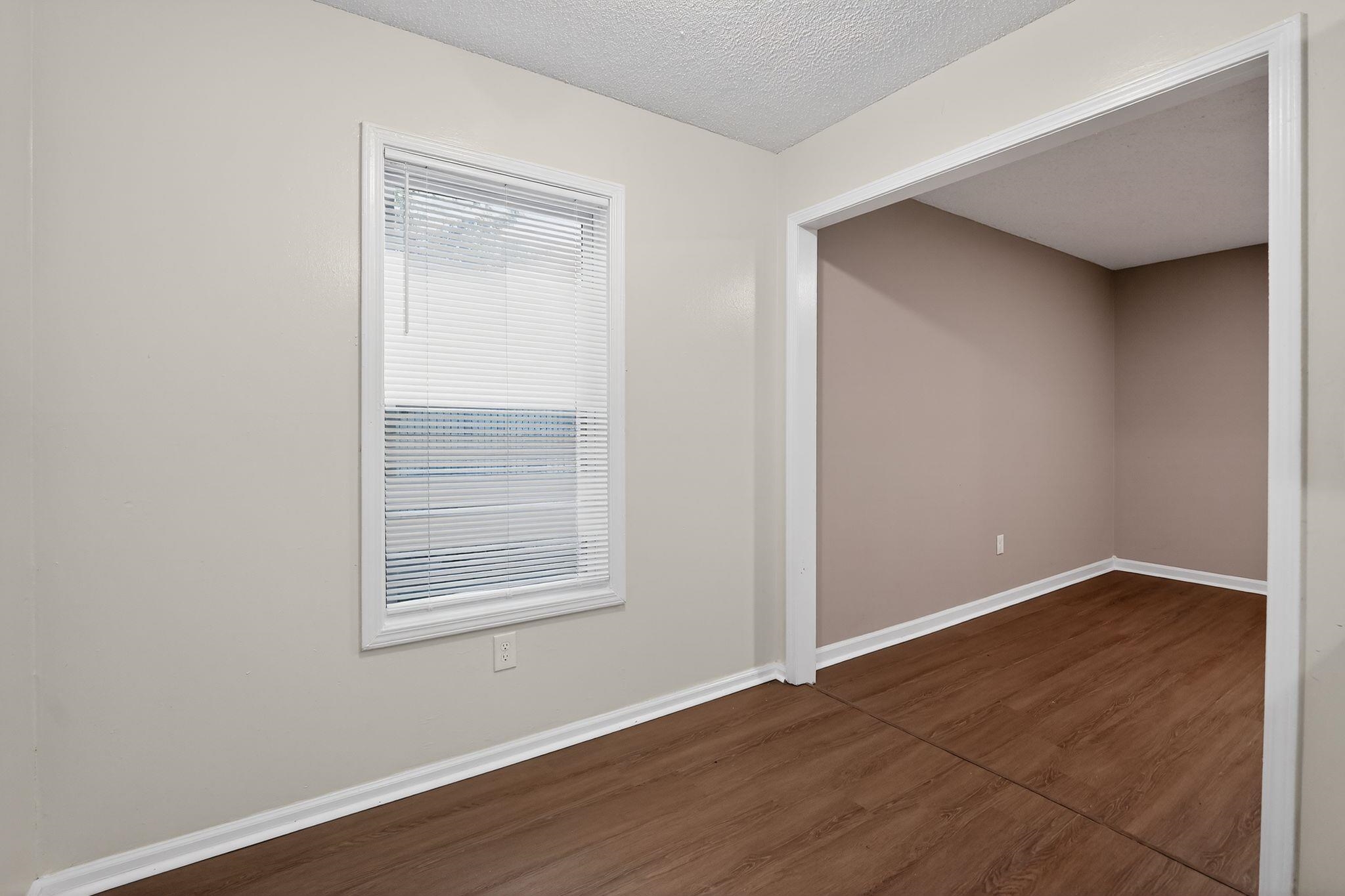 4725 Lofts Road Memphis, TN 38118 - Photo 11 of 32 Empty room featuring dark wood-style flooring and a textured ceiling