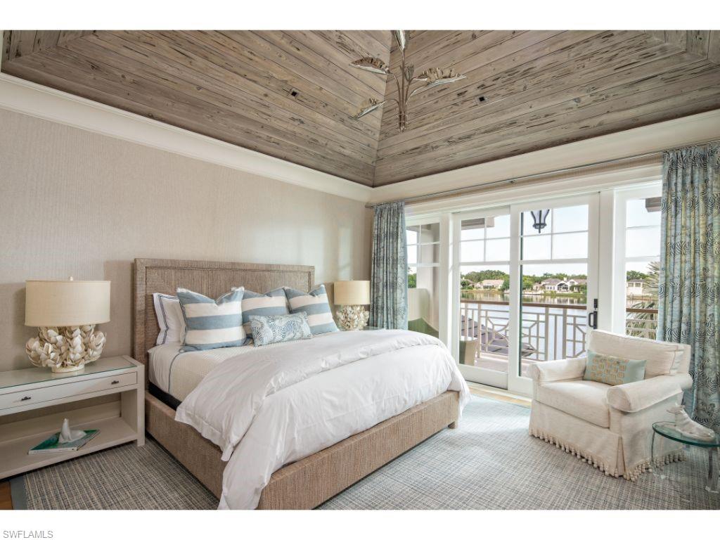3401 Rum Row Naples, FL 34102 - Photo 14 of 22 a bedroom with a large bed and a large window