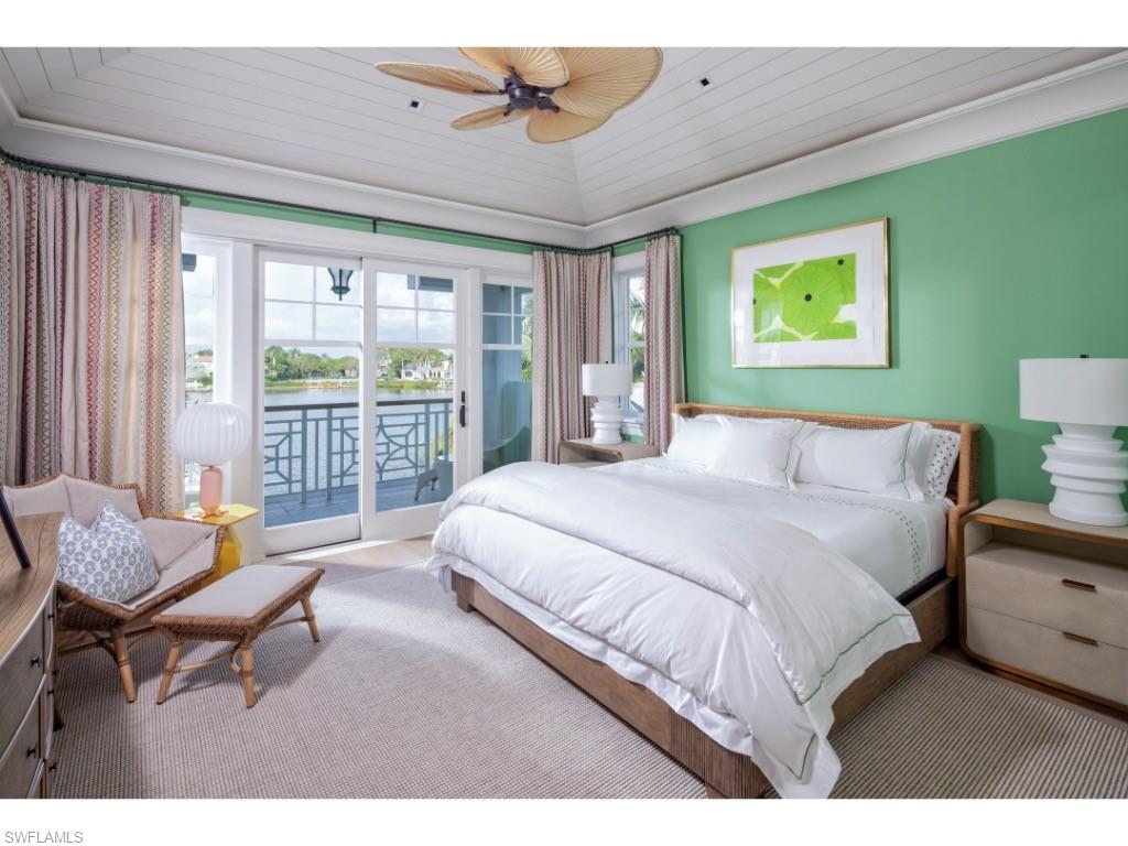 3401 Rum Row Naples, FL 34102 - Photo 16 of 22 a bedroom with a bed and wooden floor
