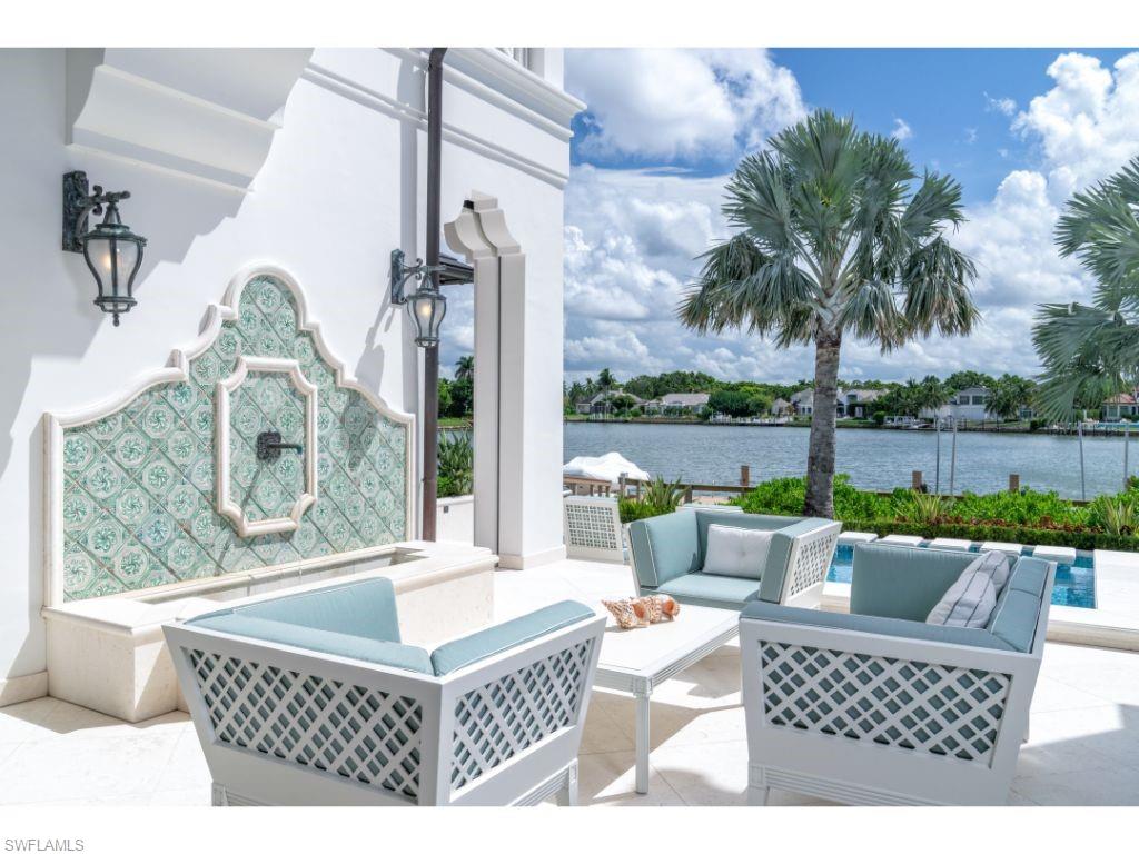 3401 Rum Row Naples, FL 34102 - Photo 19 of 22 a living room with furniture a table and a potted plant