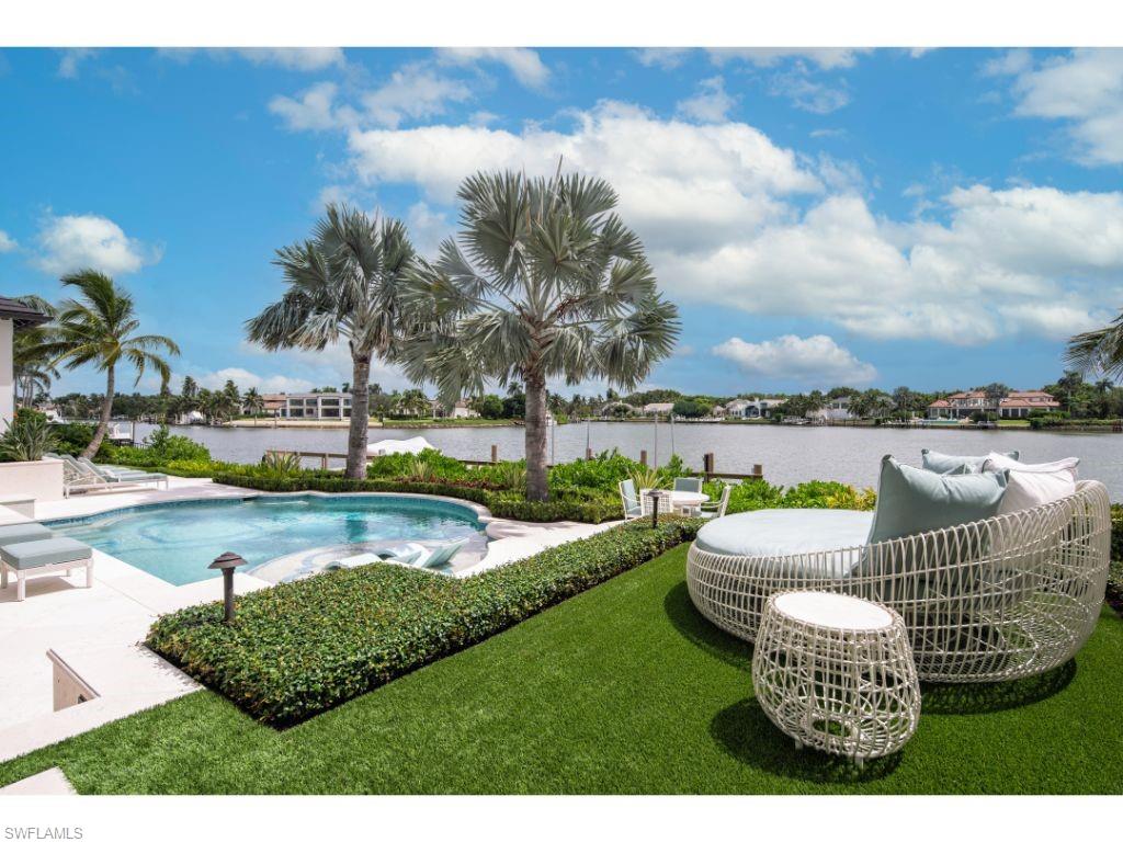 3401 Rum Row Naples, FL 34102 - Photo 20 of 22 a view of a swimming pool and lounge chairs