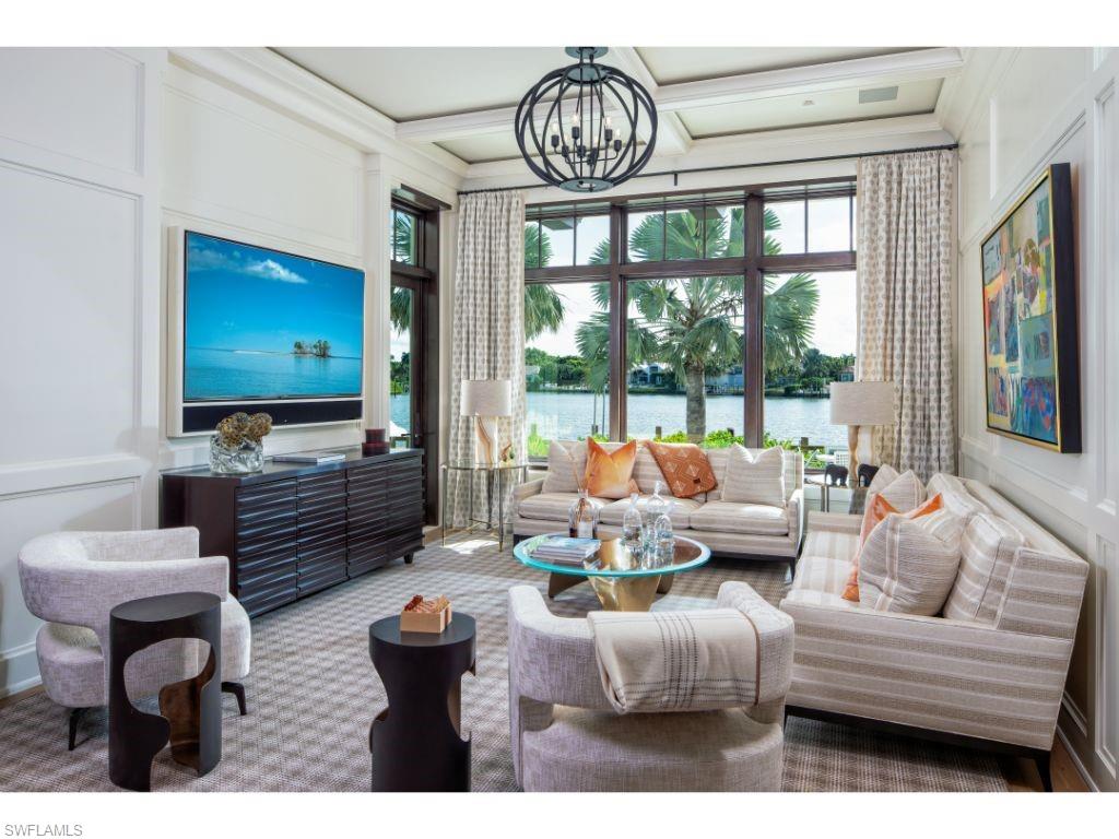 3401 Rum Row Naples, FL 34102 - Photo 10 of 22 a living room with furniture a floor to ceiling window and flat screen tv