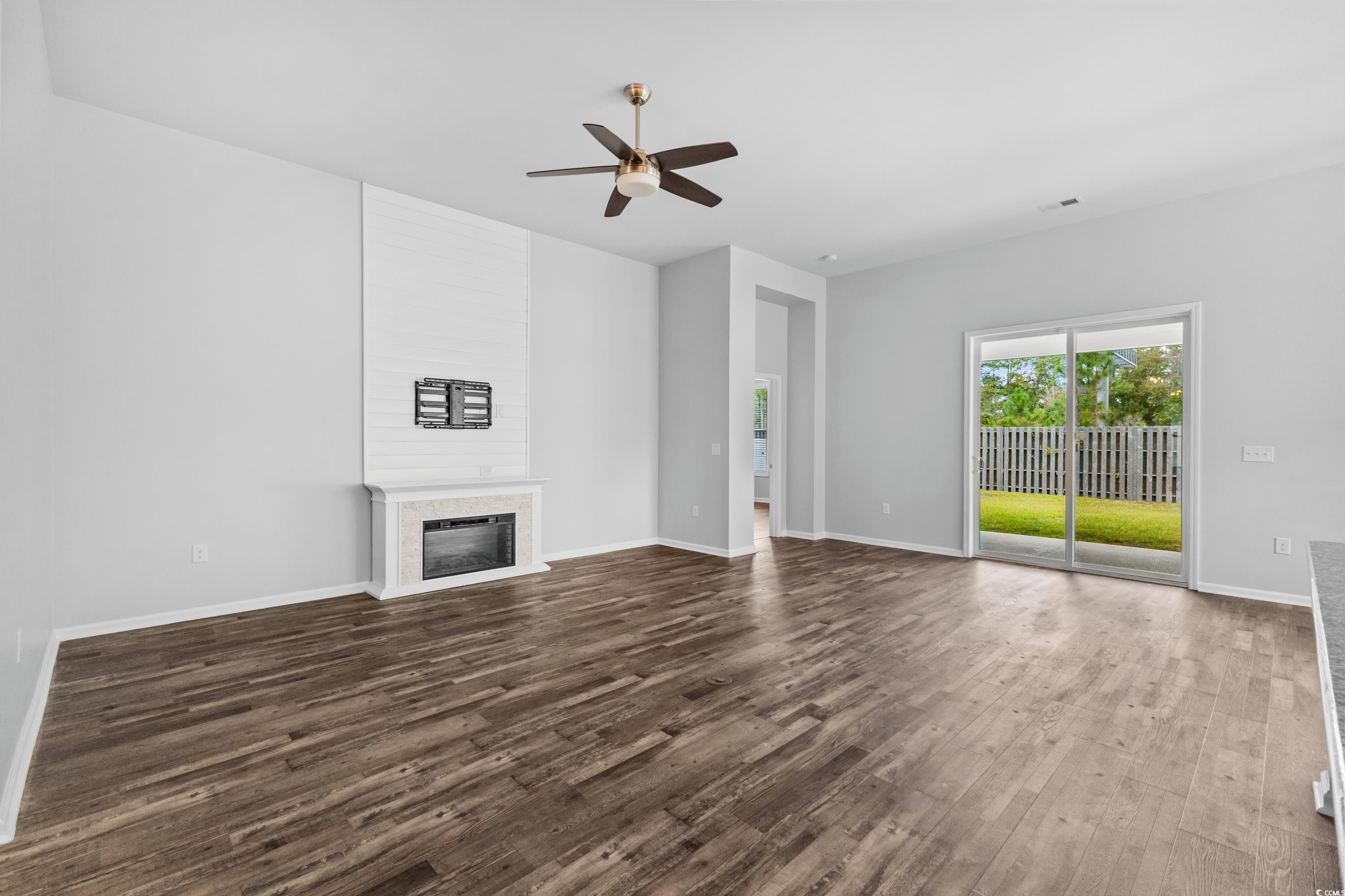 376 Firenze Loop Myrtle Beach, SC 29579 - Photo 8 of 40 Unfurnished living room with ceiling fan and hardw