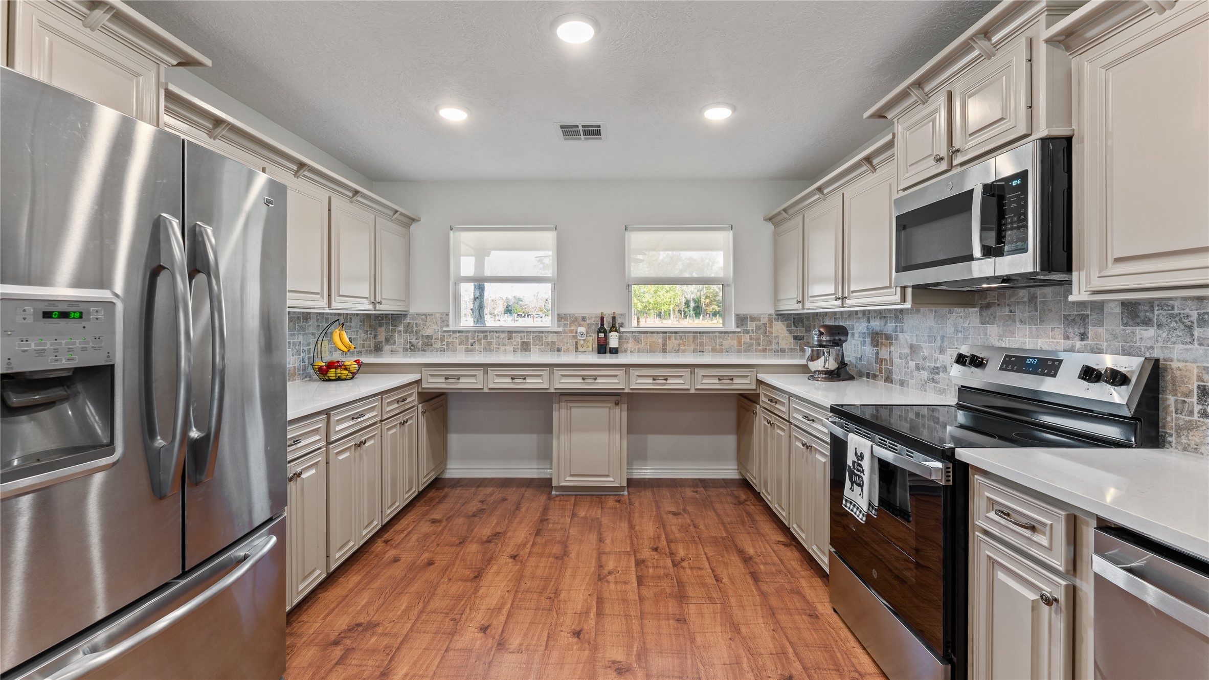 245 Alabama Point Livingston, TX 77351 - Photo 12 of 50 a kitchen with stainless steel appliances granite countertop a refrigerator a sink dishwasher a stove top oven a refrigerator with white cabinets and wooden floor