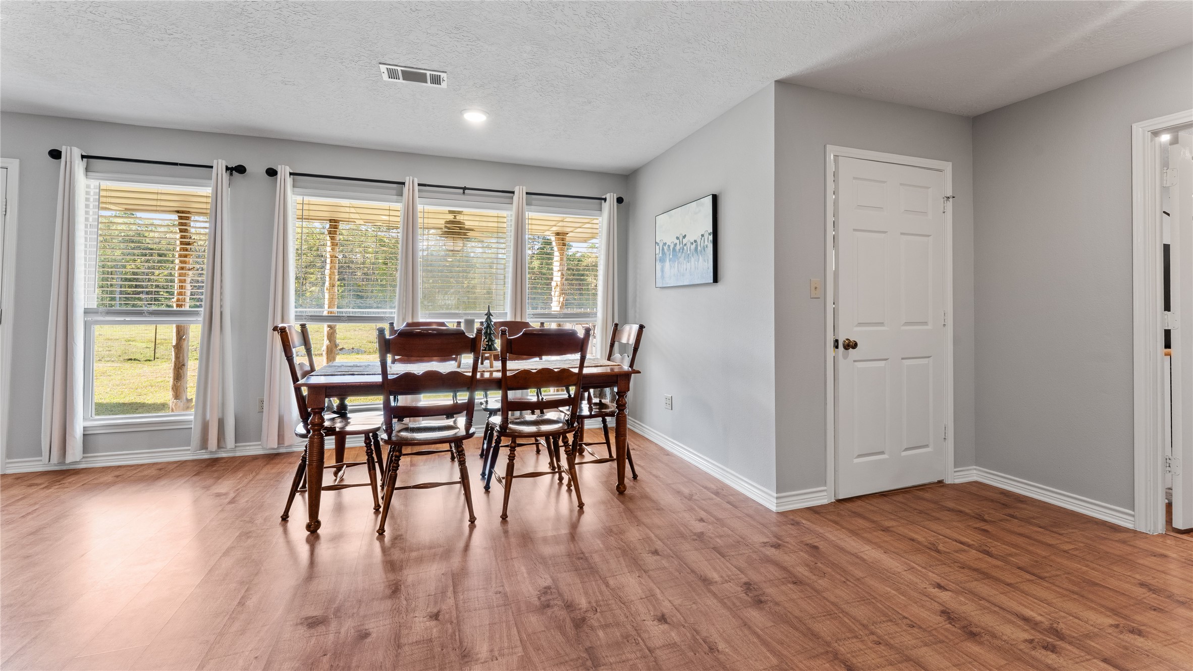 245 Alabama Point Livingston, TX 77351 - Photo 15 of 50 a view of a dining room with furniture and wooden floor