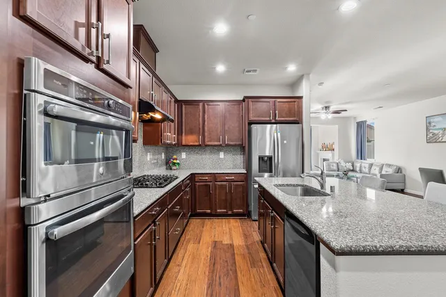 a living room with furniture floor to ceiling window and a flat screen tv