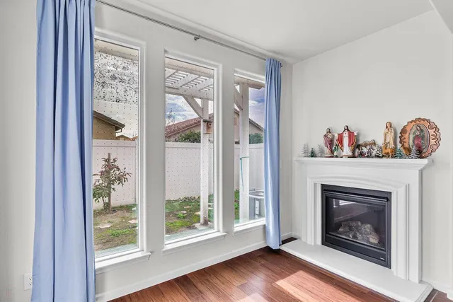 a view of a hallway with wooden floor and a chandelier