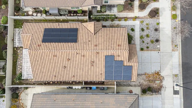 a front view of a garden with fountain and large trees