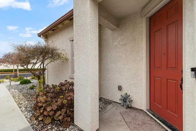 a kitchen with kitchen island granite countertop a sink and a refrigerator